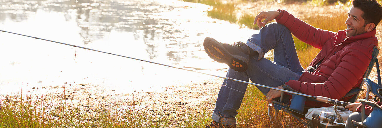 Man enjoying a fishing trip to a lake.